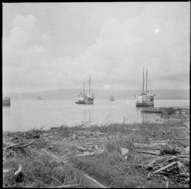 Three moored ships with one under sail in the background, and the Beehives, Rabaul Harbour, New Guinea, ca. 1936 / Sarah Chinnery