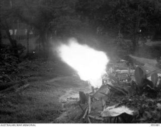 BARGES HILL, CENTRAL BOUGAINVILLE, 1945-06-26. A TROOP, 10 BATTERY, 4 FIELD REGIMENT, IS CONTINUOUSLY HARASSING THE JAPANESE WITH FIRE AND GIVING THEM NO REST DAY OR NIGHT. SHOWN, LAYING HARASSING ..