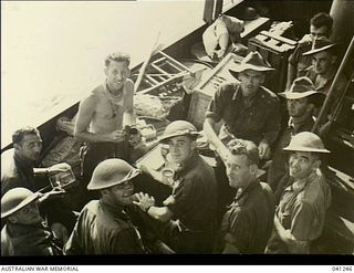 At Sea, off Papua. 1942-12-14. Members of the AIF partaking of a meal aboard HMAS Broome before disembarking to go into action at Buna