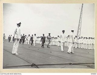 AT SEA OFF RABAUL, NEW BRITAIN. 1945-09-06. THE SURRENDER CEREMONY ABOARD THE AIRCRAFT CARRIER HMS GLORY, SHOWING GENERAL H. IMAMURA, COMMANDER EIGHTH AREA ARMY, AND PARTY MOVING ALONG THE FLIGHT ..