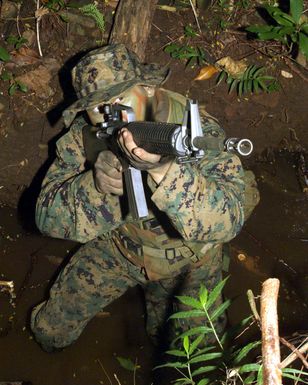 US Marine Corp (USMC) Private First Class (PFC) Jeff W Norman, 3rd Battalion, 3rd Marine Regiment, takes aim with his 5.56 mm M16A2 rifle during an exercise on the island of Oahu, Hawaii (HI)