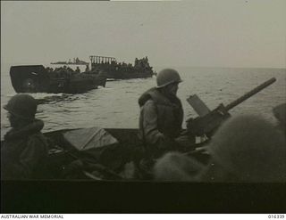 New Britain. 15 December 1943. Gunners stand to their posts as the American landing barges approach the coral shores near Arawe in one of the most daring amphibious assaults yet undertaken in this ..