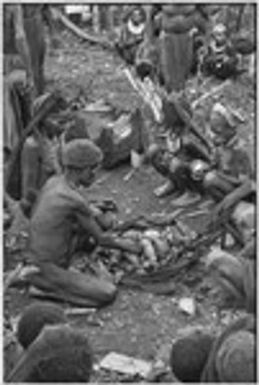 Bride price ritual: cooked yams and other foods are shared, netbag in background holds display mats