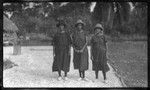 Women in hats, white shoes, and dark dresses