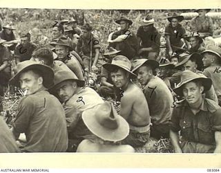 BABIANG, NEW GUINEA. 1944-11-06. MEMBERS OF C TROOP, 2/10 COMMANDO SQUADRON, LISTENING TO CAPTAIN J. ROBINSON OF ALLIED TRANSLATOR AND INTERPRETER SECTION, PRIOR TO THEIR DEPARTURE ON A STRIKE ..