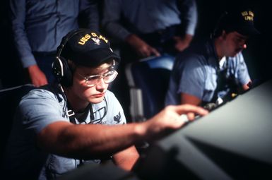 A crewman monitors a radar tracking screen aboard the amphibous assault ship USS GUAM (LPH 9)