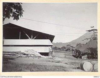 RABAUL, NEW BRITAIN. 1945-11-16. THE NEW AQ AND G STAFF BUILDINGS, HEADQUARTERS 5 BASE SUB AREA. THEIR ORIGINAL TEMPORARY TENTS ARE SITUATED ON THE RIGHT