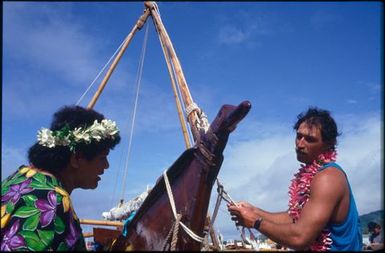 Man and woman beside bow of boat