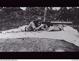 SALAMAUA, NEW GUINEA, 1940-04-?. H. WALTER, RFN NO. 88 IN THE NEW GUINEA VOLUNTEER RIFLES (NGVR) AT MACHINE GUN PRACTICE AT THE RIFLE RANGE USING A LEWIS MK 1 MACHINE GUN FOR THE FIRST TIME. (DONOR ..