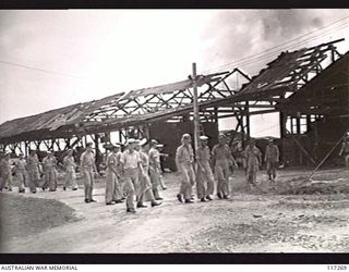 NAURU ISLAND. 1945-09-14. AUSTRALIAN SERVICE PERSONNEL LOOKING OVER THE BOMBED OUT INSTALLATIONS OF THE BRITISH PHOSPHATE COMMISSION WHARF SOON AFTER THE OCCUPATION OF THE ISLAND BY PERSONNEL OF ..