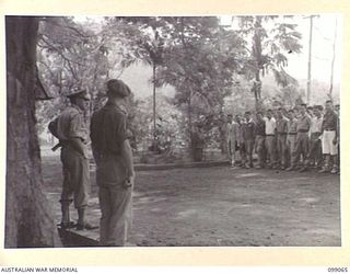 NAMANULA, NEW BRITAIN. 1945-11-21. A GROUP OF FORMOSAN AND KOREAN OFFICERS LISTENING TO MAJOR-GENERAL K.W. EATHER, GENERAL OFFICER COMMANDING 11 DIVISION. MAJ-GEN EATHER SUMMONED THEM TO DIVISION ..
