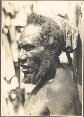 Types from villages of Evese, Ononge [close up of man with beard and headdress]