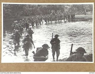 MARINGGUSIN, NEW GUINEA, 1943-09-29. "D" COMPANY, 2/14TH AUSTRALIAN INFANTRY BATTALION, 21ST AUSTRALIAN INFANTRY BRIGADE CROSSING THE YATI RIVER DURING THE MARCH FROM THE UMI RIVER TO MARRAWASA