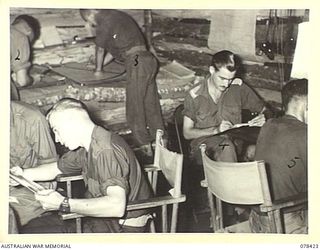 BOUGAINVILLE ISLAND. 1945-01-20. PERSONNEL OF THE 2ND FIELD REGIMENT, WORKING IN NO. 5 BATTERY COMMAND POST. IDENTIFIED PERSONNEL ARE:- WX25449 GUNNER G.M. ROBINS (1); VX147722 GUNNER D.F. ..