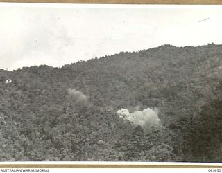 FARIA RIVER, NEW GUINEA. 1944-01-20. SMOKE RISING FROM JAPANESE POSITIONS ACROSS MAIN CREEK, AFTER A STRIKE BY ALLIED MITCHELL BOMBERS