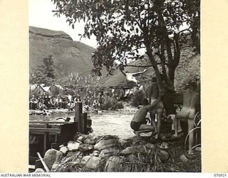 ZENAG, NEW GUINEA, 1944-02-27. A SPORTS CARNIVAL IN A CREEK DAMMED BY PERSONNEL OF THE 2/9TH FIELD COMPANY, ROYAL AUSTRALIAN ENGINEERS, GIVING 50 YARDS OF WATER, AND A DEPTH OF 6 FEET UNDER THE ..