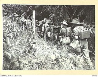 AITAPE, NEW GUINEA. 1945-03-16. MEMBERS FROM HEADQUARTERS 6TH DIVISION SIGNALS. IN JUNGLE COUNTRY SHOWING STATION ON MOVE WITH THE FOLLOWING;- SET; POWER SUPPLY AND TWO BATTERIES; CHARGER AND ..