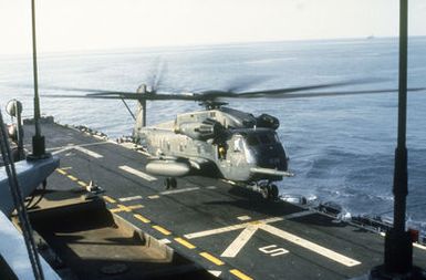 A CH-53E Super Stallion helicopter lands on the flight deck of the amphibious assault ship USS GUAM (LPH-9) during flight operations off the coast of Beirut, Lebanon