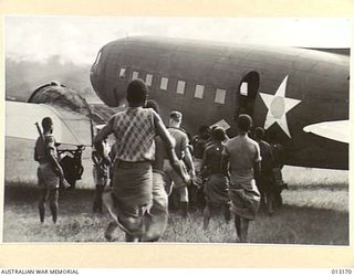 1942-09-03. A TRANSPORT AIRCRAFT ARRIVING FROM THE MAINLAND AT ONE OF THE NEW GUINEA BASES. THE ARRIVAL OF THESE AIRCRAFT IS THE OCCASION OF MUCH ESCITMENT AMONG THE LOCAL NATIVES. (NEGATIVE BY D. ..