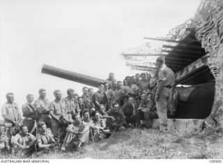 Port Moresby, New Guinea. 1944-06-06. The exterior of the gun pit where Chaplain F. M. Hill, of St John's Church of England, holds a Padre's Hour for members of the Paga Paga Battery, Coast ..