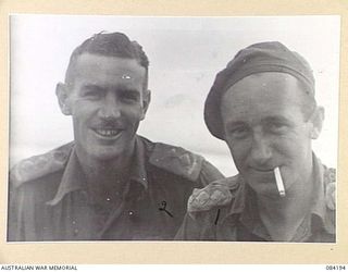 SUAIN PLANTATION, NEW GUINEA. 1944-12-09. CAPTAIN A.R. TOLMER, NEW GUINEA INFANTRY BATTALION, (1), WITH LIEUTENANT D.G. HEALEY, D COMPANY, 2/4 INFANTRY BATTALION, (2). THE TWO OFFICERS ARE ..