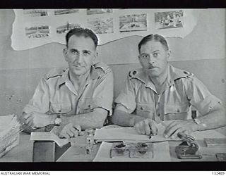 CAIRO, EGYPT. 1945-07. SITTING IN THEIR OFFICE TO THE AUSTRALIAN WAR GRAVES SERVICES, HEADQUARTERS BUILDING AT ABBASIEH ARE VX127936 WARRANT OFFICER R. M. MANGELS (LEFT) AND VX132695 MAJOR R. G. ..