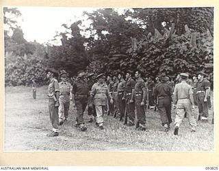 TOROKINA, BOUGAINVILLE, 1945-07-11. LIEUTENANT-GENERAL S.G. SAVIGE, GENERAL OFFICER COMMANDING 2 CORPS (1), ACCOMPANIED BY SENIOR OFFICER, INSPECTING B COMPANY, 31/51 INFANTRY BATTALION DURING HIS ..