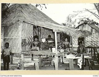 PORT MORESBY, PAPUA. 1942-07. JAPANESE BOMBING RAIDS OVER PORT MORESBY CAUSED MOST OF THE NATIVE POPULATION TO GO TO THE HILLS. A SMALL NUMBER OF NATIVE "BOYS" REMAINED, OTHERS WERE BROUGHT BACK ..