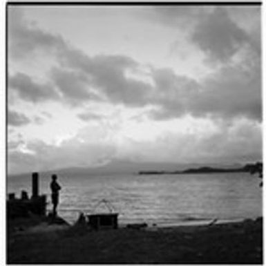 Man at shore with fishing gear