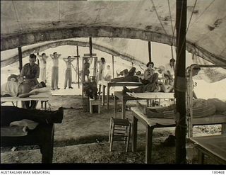 Port Moresby, New Guinea. 1944-05-29. Officers attending to patients in the Physiotherapy Department, 2/1st Australian General Hospital. Each officer attends up to ninety patients each day. ..