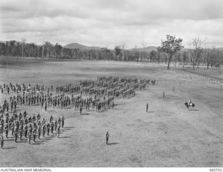 WONDECLA, QLD. 1944-04-15. GENERAL VIEW OF THE PARADE OF THE 2/1ST INFANTRY BATTALION ON THE HERBERTON RACECOURSE. TAKING THE PARADE IS NX163 LIEUTENANT COLONEL P.A. CULLEN, DSO. (ON HORSEBACK), ..