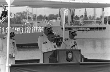 Adm. Sylvester R. Foley Jr., left, and CHIEF of Naval Operations Designate Adm. James D. Watkins stand behind the chaplain as he says a prayer at the change of command ceremony. Foley is assuming command of the U.S. Pacific Fleet