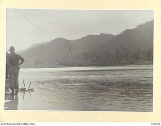 A SECTION OF HEADQUARTERS, 6TH DIVISION LOOKING SOUTH UP THE RIVER AND TAKEN FROM THE WEST BANK AT THE MOUTH. ON THE LEFT CAN BE SEEN PORTION OF THE FLYING FOX BUILT AND OPERATED BY TROOPS OF ..