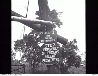 DONADABU, NEW GUINEA. 1943-11-03. SIGN OVER A SUSPENSION BRIDGE OVER A SMALL CREEK NEAR THE LALOKI RIVER AT 24TH AUSTRALIAN FIELD COMPANY, ROYAL AUSTRALIAN ENGINEERS, READS, 'CLASS 2 OR 20 INF. IN ..