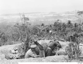 SNELL'S HILL, FINSCHHAFEN AREA, NEW GUINEA. 1944-03-27. FINSCHHAFEN HARBOUR FROM SNELL'S HILL DURING OPERATIONS ON THE 26TH INFANTRY BRIGADE A CAPTURED JAPANESE GUN POSITION IS IN THE FOREGROUND