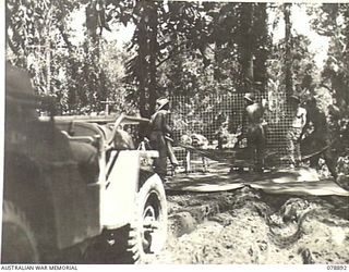 BOUGAINVILLE ISLAND. 1945-02-04. TROOPS OF THE 5TH FIELD COMPANY, LAYING PAPER ON WIRE MESH FOR STORING THEIR SHELLS