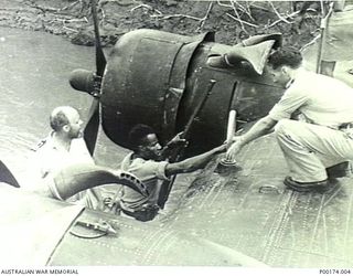 NEW GUINEA, 1942-1943. POSSIBLY WAIROPE RIVER - PROBABLY A NAVY COASTWATCHER FLOWN IN BY CATALINA PREPARING TO GO ASHORE WITH A MEMBER OF THE COASTWATCHING PARTY. (4 OF 5)