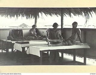 LAE, NEW GUINEA. 1944-07-14. PATIENTS RECEIVING TREATMENT IN THE PHYSIOTHERAPY DEPARTEMNT OF THE 2/7TH AUSTRALIAN GENERAL HOSPITAL. IDENTIFIED PERSONNEL:- NX131608 PRIVATE S.H. SALTER (1); SFX1109 ..
