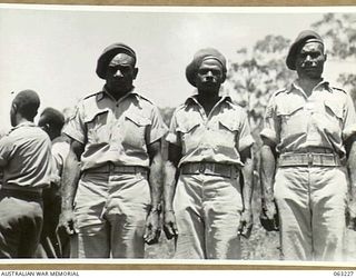 SOUTHPORT, QLD. 1944-01-18. NEW GUINEA POLICE BOYS PROUDLY DISPLAY BERETS PRESENTED TO THEM BY MEMBERS OF THE 4TH ARMOURED BRIGADE DURING THEIR STAY WITH THE UNIT WHILE DOING A TANK FAMILIARIZATION ..