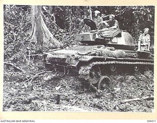 TOROKINA, BOUGAINVILLE, 1945-07-03. AN M24 GENERAL OFFICE LIGHT TANK BOGGED IN THICK MUD DURING TRIALS CONDUCTED FOR THE WAR OFFICE