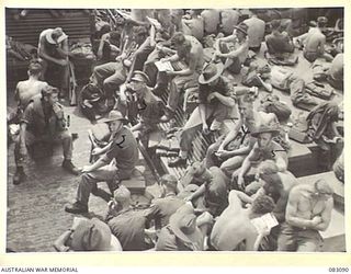 TROOPS OF 2/4TH INFANTRY BATTALION, HQ 19TH INFANTRY BRIGADE, USE A SMALL PROMENADE OF A DECK ABOARD THE AMERICAN TROOPSHIP MEXICO TO REST AND WATCH THE DISAPPEARING COASTLINE OF PAPUA DURING THEIR ..