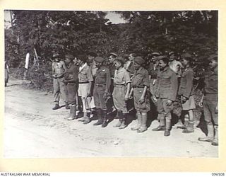MALAGUNA MISSION, RABAUL, NEW BRITAIN, 1945-09-10. MEMBERS OF 29/46 INFANTRY BATTALION, WITH A GROUP OF JAPANESE NAVAL PERSONNEL WHO WERE RELEASED FROM JAPANESE CONTROL AFTER THE OCCUPATION OF ..