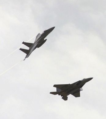 A pair of F-15 Eagle fighters from the 44th Fighter Squadron (FS), Kadena Air Force Base (AFB), Okinawa, Japan, perform aerial maneuver over the skies of Andersen AFB, Guam