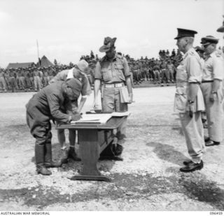 CAPE WOM, NEW GUINEA, 1945-09-13. LIEUTENANT-GENERAL H. ADACHI, COMMANDER 18 JAPANESE ARMY IN NEW GUINEA, SIGNING THE INSTRUMENT OF SURRENDER. HE ACCEPTED THE TERMS UNCONDITIONALLY. ..