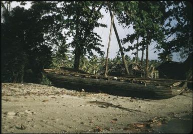 A canoe on the shore, at Mapamoiwa village : Mapamoiwa village, D'Entrecasteaux Islands, Papua New Guinea, 1956 / Terence and Margaret Spencer