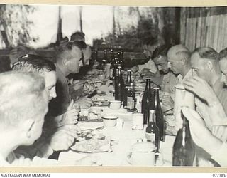 MALMAL MISSION, JACQUINOT BAY, NEW BRITAIN. 1944-11-24. OFFICERS OF B COMPANY, 594TH ENGINEER BOAT AND SHORE REGIMENT UNITED STATES ARMY AND THEIR AUSTRALIAN GUESTS ENJOYING THE TRADITIONAL ..