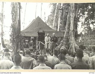 MALMAL MISSION, JACQUINOT BAY, NEW BRITAIN. 1944-11-24. CHAPLAIN SMYTH, AUSTRALIAN MILITARY FORCES, CONDUCTING A SHORT THANKSGIVING SERVICE FOR THE TROOPS OF THE 594TH ENGINEER BOAT AND SHORE ..