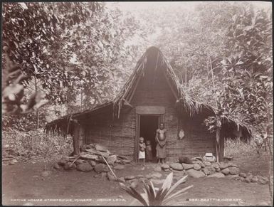 A man and two children at a house in St. Patricks, Vanua Lava, Banks Islands, 1906 / J.W. Beattie