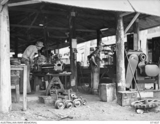 LAE, NEW GUINEA. 1944-03-24. NX103389 CRAFTSMAN H. NIXON (1), WITH NX65373 STAFF SERGEANT J. SWANSON (2), OPERATING LATHES IN THE REPAIRS MACHINE SHOP, 2ND MECHANICAL EQUIPMENT WORKSHOP, ELECTRICAL ..