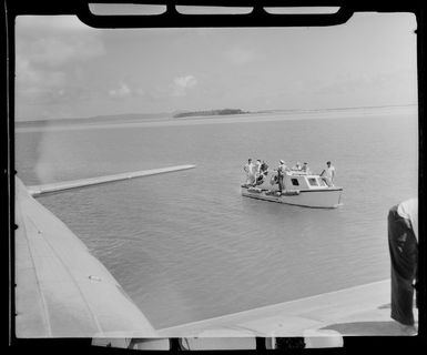 Passengers on boat to board TEAL (Tasman Empire Airways Limited) Flying boat, Akaiami, Aitutaki, Cook Islands